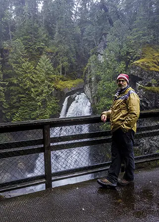 Photo of Man standing by a waterfall on Vancouver Island BC